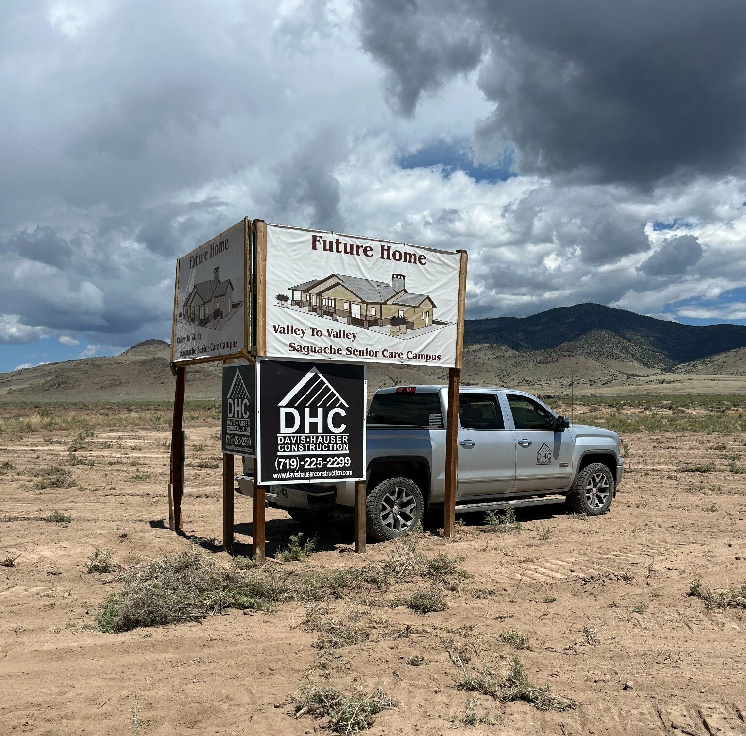 Das Hauser Construction Custom Home Builder in Salida - DHC sign on building zone by truck